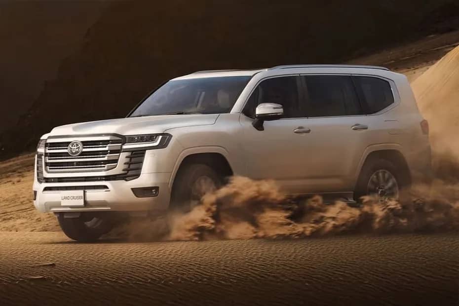 A Land Cruiser kicking up sand on the dunes